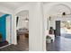 Open hallway with arched doorways, connecting the living spaces with modern flooring at 9291 Geranium Ave, Spring Hill, FL 34606