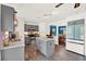 Modern kitchen featuring grey cabinets, a kitchen island, and stainless steel appliances at 9291 Geranium Ave, Spring Hill, FL 34606