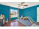 Vibrant room with bright blue walls, a large window, and play equipment at 9291 Geranium Ave, Spring Hill, FL 34606