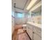 Bathroom featuring a vanity with white cabinets and a shower-tub combo at 9512 Sunshine Blvd, New Port Richey, FL 34654