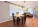 Bright dining area with a view of the living room with recliner and brick accent wall at 9512 Sunshine Blvd, New Port Richey, FL 34654