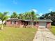 Inviting brick house with a one-car garage and a well-maintained lawn in a sunny location at 9512 Sunshine Blvd, New Port Richey, FL 34654