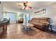 Comfortable living room featuring couches, side table, and ceiling fan at 9512 Sunshine Blvd, New Port Richey, FL 34654