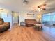 Open-concept living room featuring an accent wall and vinyl floors at 9512 Sunshine Blvd, New Port Richey, FL 34654