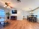 Cozy living room with ceiling fan and an adjacent dining area at 9512 Sunshine Blvd, New Port Richey, FL 34654