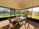 Screened patio features a ceiling fan and a view of a pond at 9512 Sunshine Blvd, New Port Richey, FL 34654