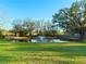 Lush backyard featuring a tranquil pond and fountain at 9512 Sunshine Blvd, New Port Richey, FL 34654