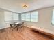 A bright sunroom with a table and chairs and a daybed for relaxing at 9512 Sunshine Blvd, New Port Richey, FL 34654