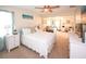 Spacious bedroom with multiple beds, beachy decor, and ample natural light creating a relaxing atmosphere at 9525 Via Segovia, New Port Richey, FL 34655