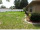 Backyard with a well-maintained lawn and white vinyl fence for privacy at 10020 Vancouver Rd, Spring Hill, FL 34608