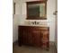 Bathroom vanity with dark wood cabinets, marble countertop and tiled floors at 10020 Vancouver Rd, Spring Hill, FL 34608