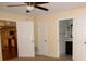 Comfortable bedroom with views of the kitchen and bath, featuring ceiling fan and neutral walls at 10020 Vancouver Rd, Spring Hill, FL 34608