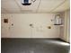 Garage featuring a gray concrete floor, water heater and access door at 10020 Vancouver Rd, Spring Hill, FL 34608