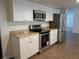 Modern kitchen featuring granite countertops and stainless steel appliances at 10020 Vancouver Rd, Spring Hill, FL 34608