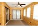 Bright sunroom features wood paneling, and sliding glass doors to yard at 10020 Vancouver Rd, Spring Hill, FL 34608