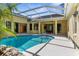 Beautiful screened-in pool with patio and access to kitchen and living area at 10079 Deer St, Spring Hill, FL 34608