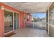 Enclosed back porch featuring neutral tiles and screen windows with backyard view at 10469 Ireland St, Spring Hill, FL 34608