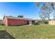 View of the exterior and backyard with a storage shed and green lawn at 10469 Ireland St, Spring Hill, FL 34608