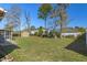 Large grassy backyard featuring a storage shed and ample space for outdoor activities at 10469 Ireland St, Spring Hill, FL 34608