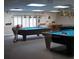 Billiard room features Diamond tables, pendant lights, and neutral carpet at 11140 Carriage Hill Dr # 3, Port Richey, FL 34668
