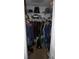Walk-in closet with rods, shelves, clothing, cleaning equipment and other items, providing ample storage solutions at 11140 Carriage Hill Dr # 3, Port Richey, FL 34668