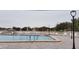 A refreshing community pool surrounded by lounge chairs and views of the lake at 11140 Carriage Hill Dr # 3, Port Richey, FL 34668