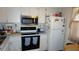 Well-equipped kitchen featuring a stainless steel microwave and ample counter space for meal preparation at 11140 Carriage Hill Dr # 3, Port Richey, FL 34668