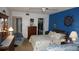 Spacious bedroom with bright blue accent wall, two beds, and a walk-in closet at 11140 Carriage Hill Dr # 3, Port Richey, FL 34668