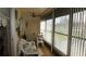 Bright sunroom with large windows, white wicker furniture, a ceiling fan, and a view of the yard at 11140 Carriage Hill Dr # 3, Port Richey, FL 34668