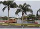 Picturesque waterfront view featuring palm trees, a gazebo, a fountain, and tranquil scenery at 11140 Carriage Hill Dr # 3, Port Richey, FL 34668