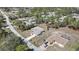 Aerial view of a well-maintained home with a long driveway and lush, mature landscaping in a quiet neighborhood at 11257 Frigate Bird Ave, Weeki Wachee, FL 34613