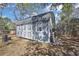 The backyard includes a grey, well-kept storage shed with double doors, windows and grey metal roof at 11257 Frigate Bird Ave, Weeki Wachee, FL 34613