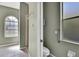 View of the bathroom featuring a shower stall, toilet, and arched window for natural lighting at 11257 Frigate Bird Ave, Weeki Wachee, FL 34613