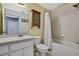 A bathroom with white fixtures, yellow walls, and a tiled shower/tub at 11257 Frigate Bird Ave, Weeki Wachee, FL 34613
