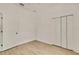 A bedroom with neutral walls, wood-look flooring, and a closet at 11257 Frigate Bird Ave, Weeki Wachee, FL 34613