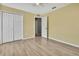 Bedroom with yellow walls, wood-look floors, and a closet at 11257 Frigate Bird Ave, Weeki Wachee, FL 34613