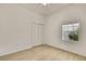 A bedroom with neutral walls, wood-look flooring, and a window at 11257 Frigate Bird Ave, Weeki Wachee, FL 34613