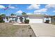 Charming single-story home with a two-car garage, and manicured front lawn at 11257 Frigate Bird Ave, Weeki Wachee, FL 34613