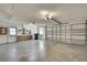 Spacious garage with overhead door, side entry door, and ample room for storage and vehicles at 11257 Frigate Bird Ave, Weeki Wachee, FL 34613