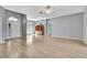 Spacious open-concept living room featuring wood-look flooring and a front entrance with decorative glass at 11257 Frigate Bird Ave, Weeki Wachee, FL 34613