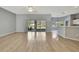 Open concept living room with plenty of natural light and wood flooring at 11257 Frigate Bird Ave, Weeki Wachee, FL 34613