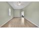 Large main bedroom featuring wood-look flooring, vaulted ceiling and a sliding door to the lanai at 11257 Frigate Bird Ave, Weeki Wachee, FL 34613