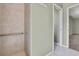 Tile shower stall featuring a grab bar and is located near the adjacent toilet and sink at 11257 Frigate Bird Ave, Weeki Wachee, FL 34613