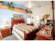 Bright bedroom with ceiling fan, wooden bed, bedside tables, and floral decor at 11612 Sheffield Rd, Spring Hill, FL 34608