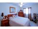 Comfortable bedroom with wooden bed frame, dresser, and patterned curtains at 11612 Sheffield Rd, Spring Hill, FL 34608