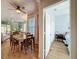 Dining room and bedroom view with a ceiling fan, connecting to the living room at 11723 Foxworth Ln, New Port Richey, FL 34654