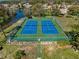 Aerial view of two community tennis courts surrounded by a green fence, offering recreation and leisure opportunities at 11723 Foxworth Ln, New Port Richey, FL 34654