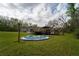 Exterior of home, showing the large deck and pool in the backyard at 13024 Mohican Ave, New Port Richey, FL 34654
