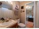 Charming bathroom with neutral wallpaper, decorative cow artwork, and a connecting door to a bedroom at 13024 Mohican Ave, New Port Richey, FL 34654