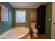 Bathroom showcasing a soaking tub, neutral decor, and storage solutions at 13024 Mohican Ave, New Port Richey, FL 34654